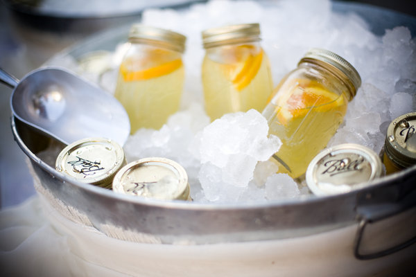 Backyard cookout decor featuring jars of lemonade on ice.