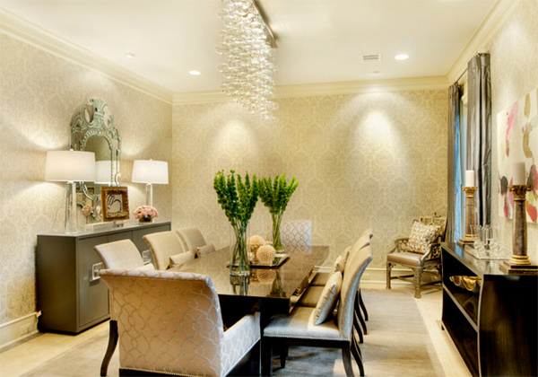 A formal dining room with beige walls and a chandelier decorated with gold.