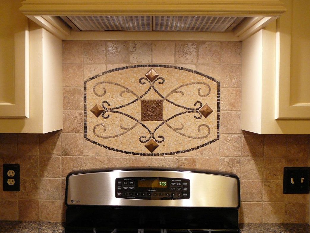 A kitchen with a stove and decorative tiled backsplash.