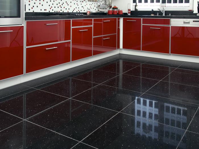 A trendy black and red kitchen.