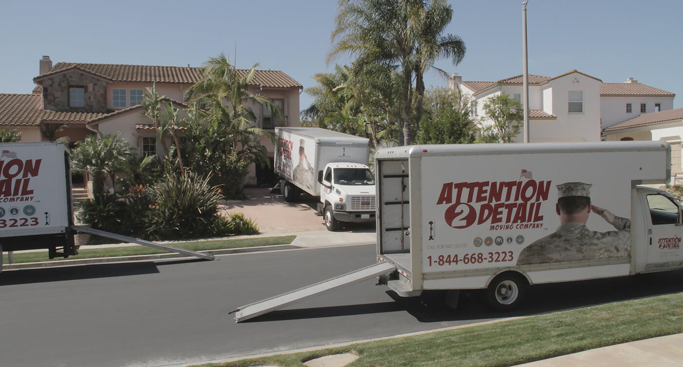 A moving truck is parked in front of a house, providing 3 tips for planning your next move.