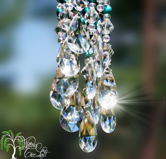 Swarovski crystal sun catcher hanging from a tree.