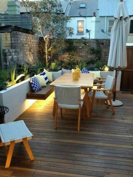 A backyard deck with a table and chairs.