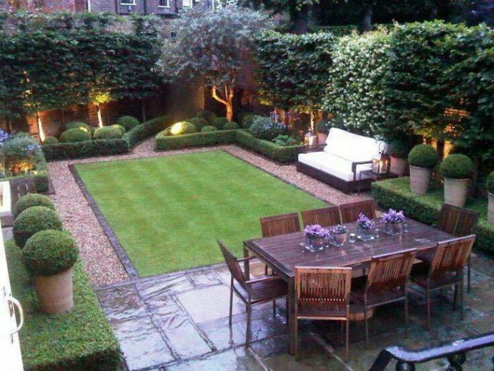 A small backyard garden with lawn and furniture.