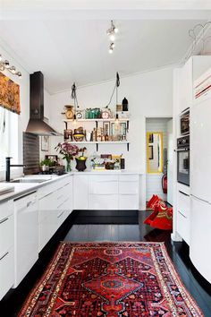 A Swedish kitchen with a rug on the floor.