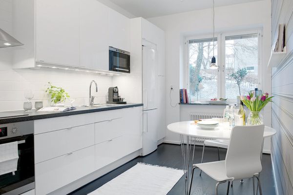 A Swedish kitchen with a table and chairs.