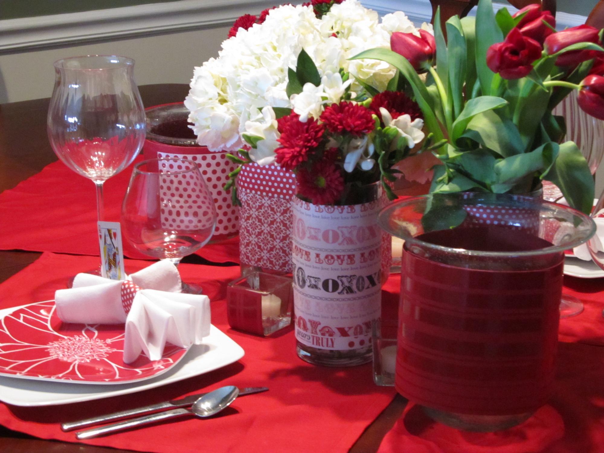 A red tablecloth for Valentine's Day decor on the table.