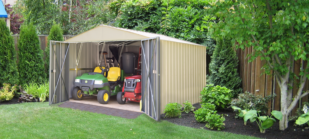 A metal shed in a backyard with a lawn mower for winter gardening.