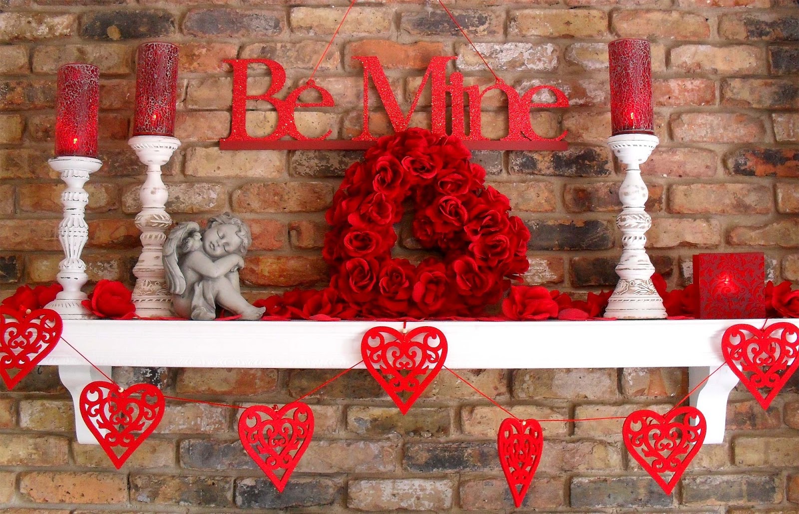 Valentine's Day decor with red hearts on a brick mantel.