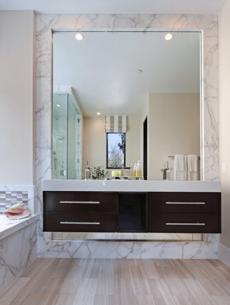 A bathroom featuring a large mirror.