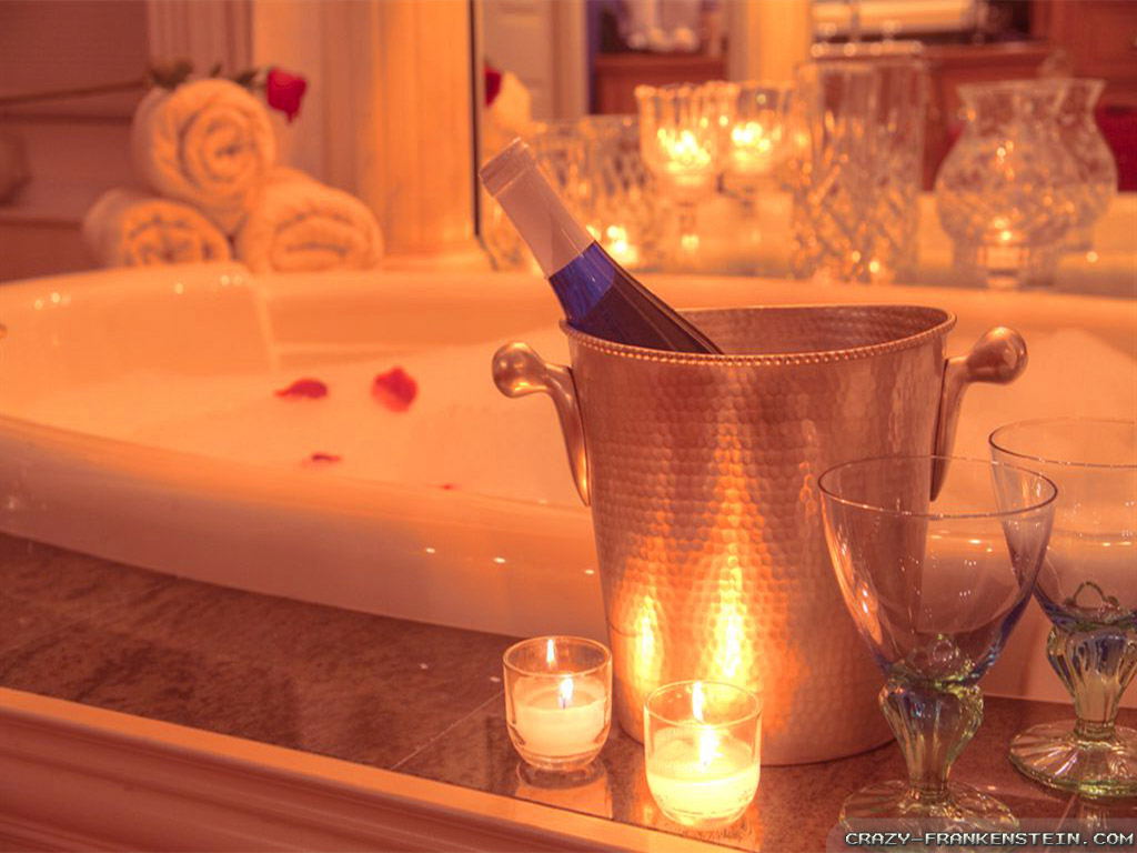 A champagne bottle complements Valentine's Day decor on a table next to a bathtub.