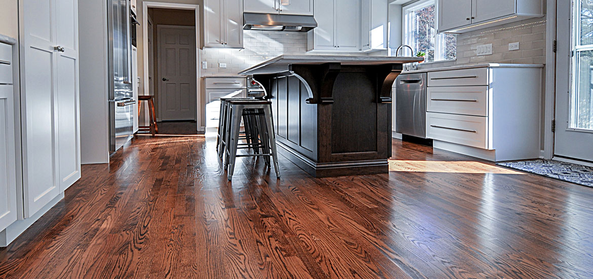A hardwood floor in a kitchen.