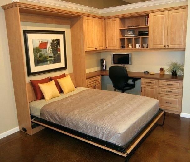 A stylish bedroom with a bed, desk, and cabinets in an apartment.