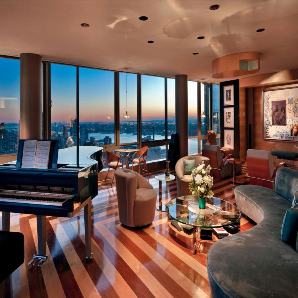 A new york city penthouse featuring a piano in the living room.