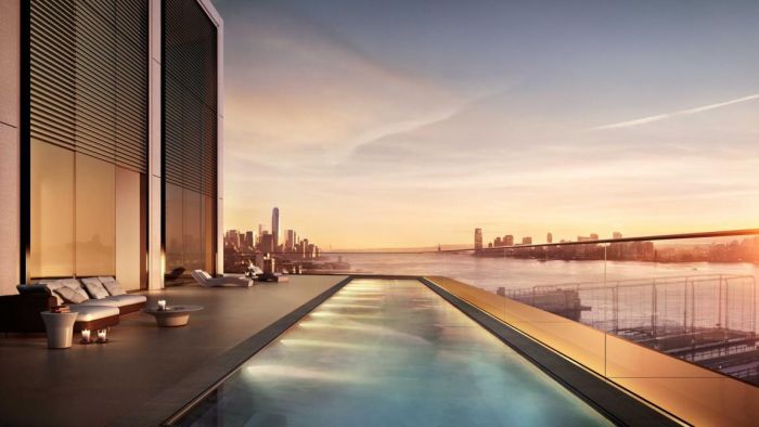 A new york city penthouse with a rooftop pool overlooking the city at sunset.