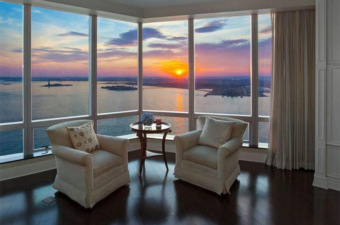 A new york city penthouse living room with a view of the water.