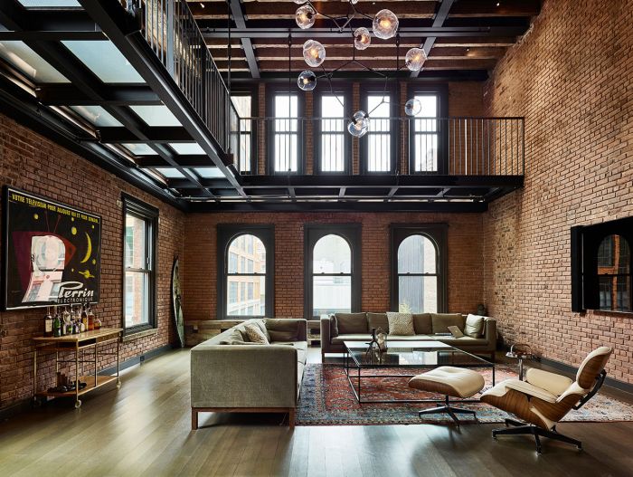 A new york city penthouse apartment with brick walls and wooden floors.