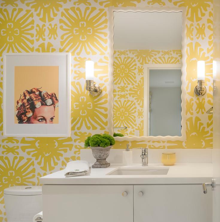 A tiny bathroom with yellow and white wallpaper.