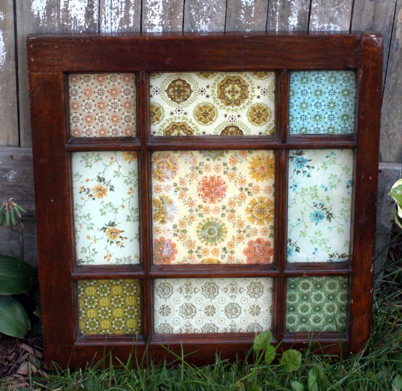 A wooden window frame with a floral pattern made from leftover wallpaper.