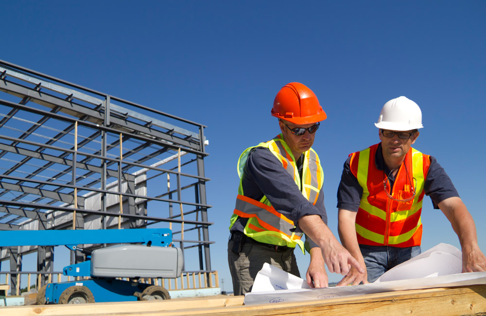 Two construction workers at a construction site for a Construction Company.