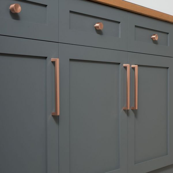 Update cabinets with simple copper drawer pulls.