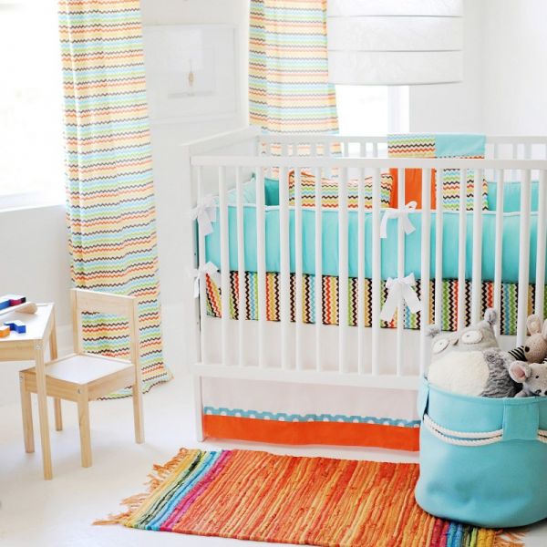 A gender neutral nursery with a crib, changing table, and rug.