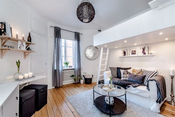 The calm white loft over adds an interesting detail to this white and airy studio apartment.