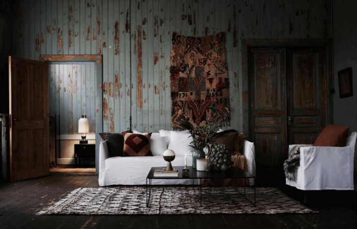 A wabi sabi living room with wooden walls and a rug.