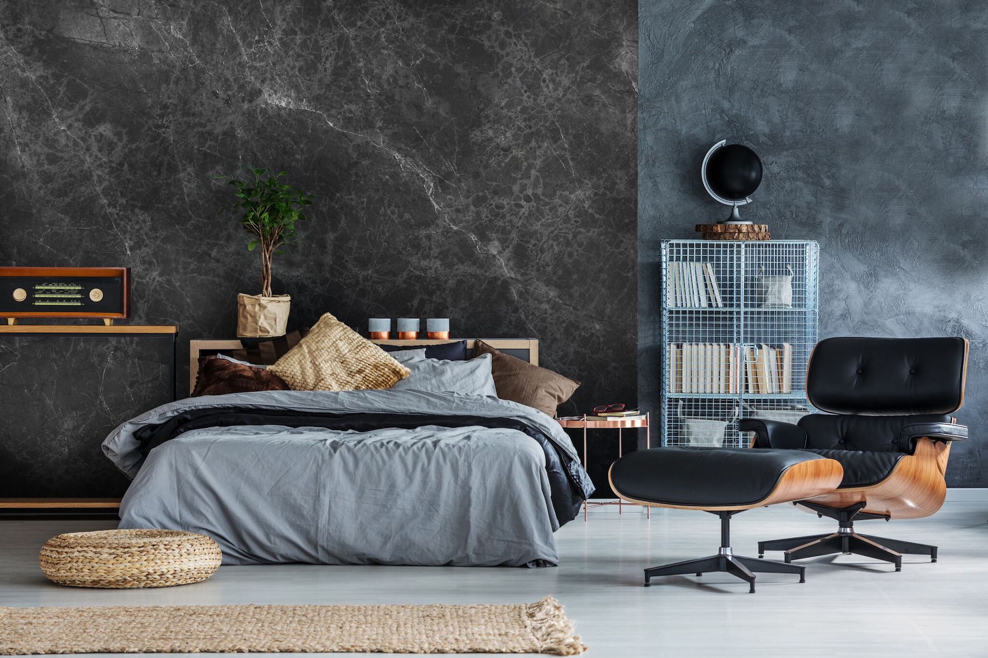 A bedroom with a wabi sabi inspired black marble wall.