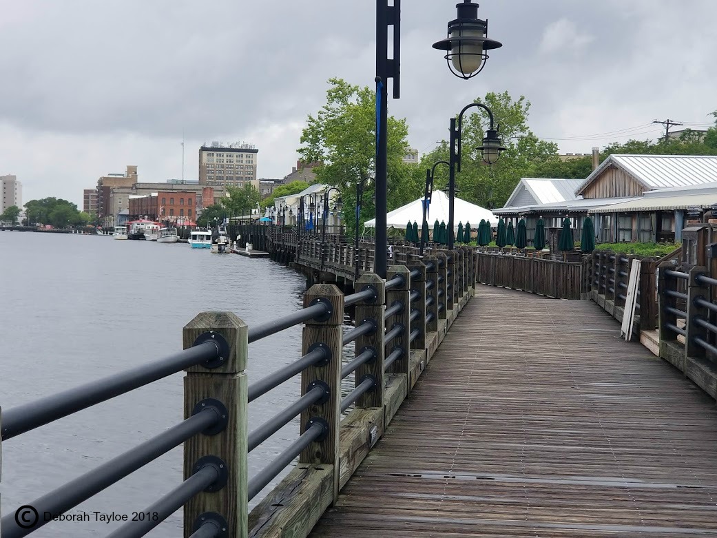 A wooden boardwalk in Wilmington leading to the water.
