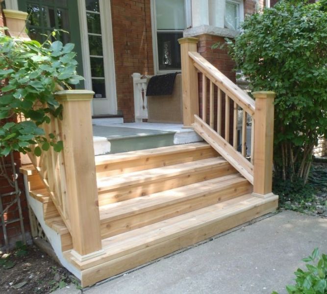 A DIY wooden staircase with a planter in front of it.