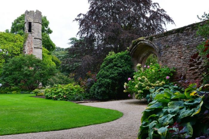 A garden with a stone tower in the background showcasing DIY hacks.