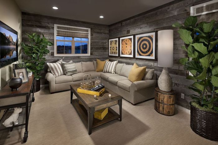 A living room with a wood accent wall and a couch.