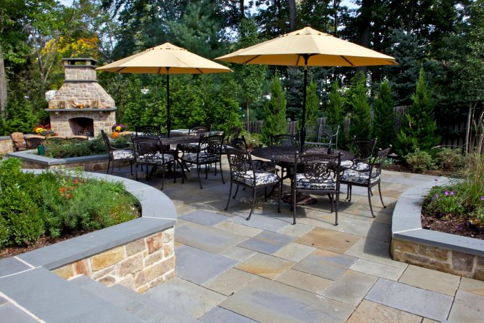 A patio with umbrellas and fire pit.