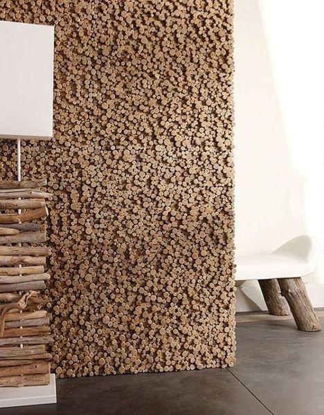 Wood accent wall made of logs in a living room.