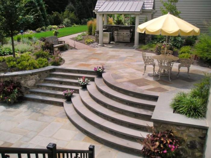 Stone pavers give a touch of elegance with raised areas and rounded steps (HGTV)