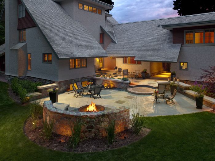 A spacious backyard with a fire pit and patio.