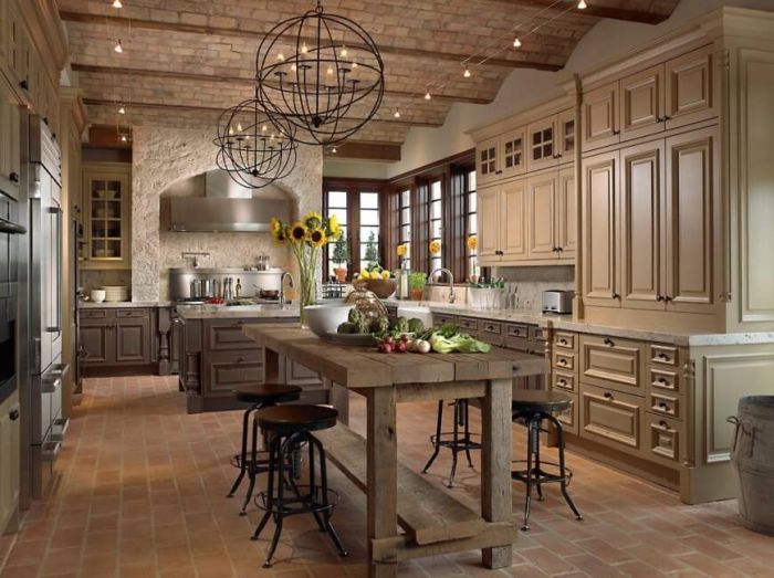 A kitchen with a large island and brilliant lighting.