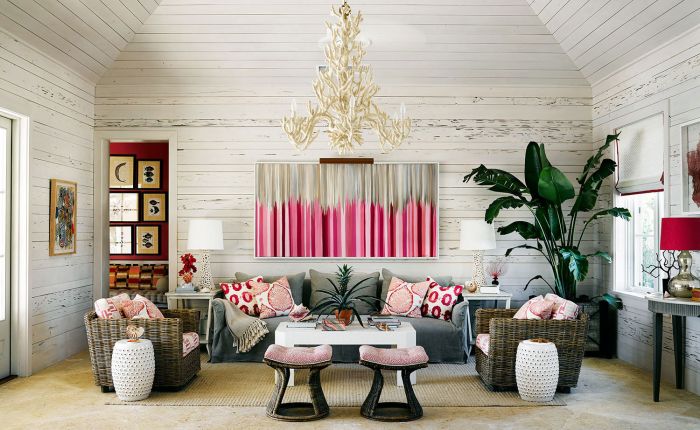 A living room with island-style wicker furniture and pink accents.