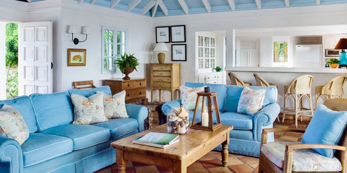 A living room with blue couches and an island style coffee table.