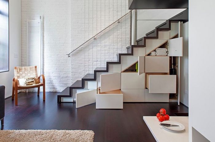 Designer tips for creating a white living room with storage and a staircase.