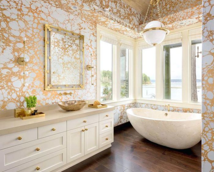The gold wallpaper is the crown jewel of this posh bath