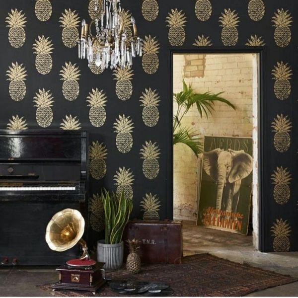 A living room with a piano and metallic wallpaper.