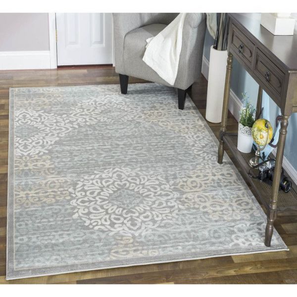 A dreamy living room rug featuring a grey and white floral pattern.