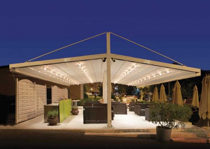 A patio with a retractable roof at night.