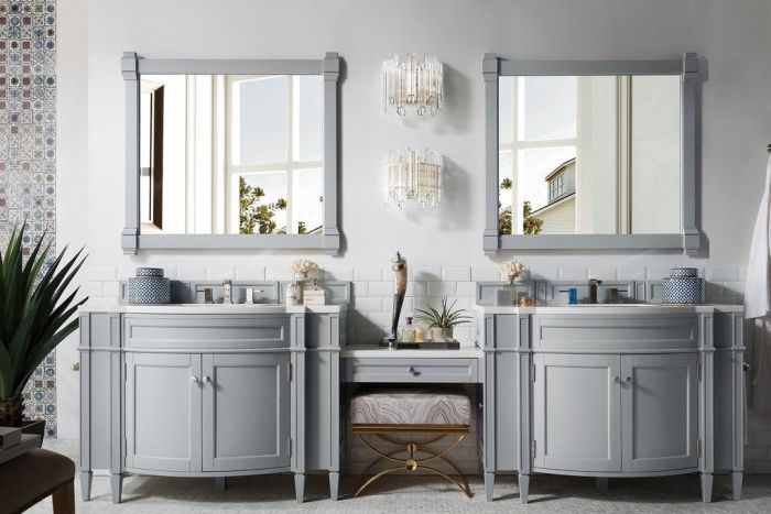 A dual sink vanity with mirrors.