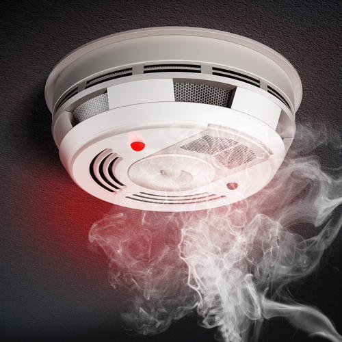 A smoke detector emitting smoke for home safety.