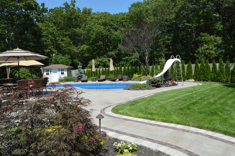 Poolside backyard with a slide.