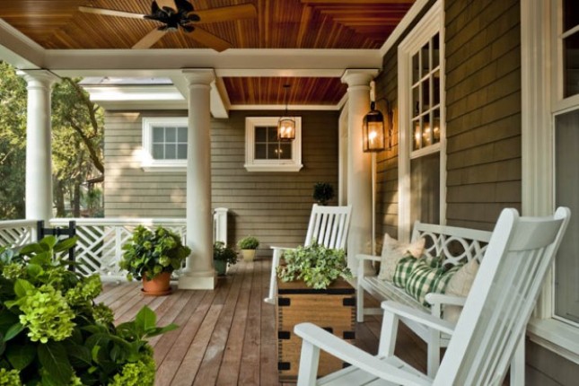 A front porch with two rocking chairs that would enhance home improvement projects.