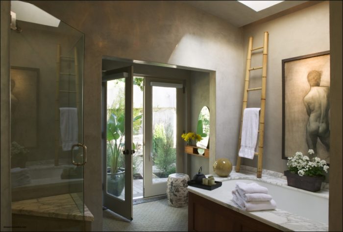 A spa bathroom with a painting on the wall.